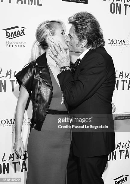 Johnny Hallyday kisses his wife Læticia Hallyday during 'Salaud On T'Aime' Paris Premiere at Cinema UGC Normandie on March 31, 2014 in Paris, France.