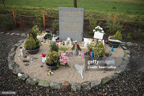 Candles, flowers, photos and messages left by mourners lie at a memorial to the victims of the Germanwings flight 4U9525 crash following a memorial...