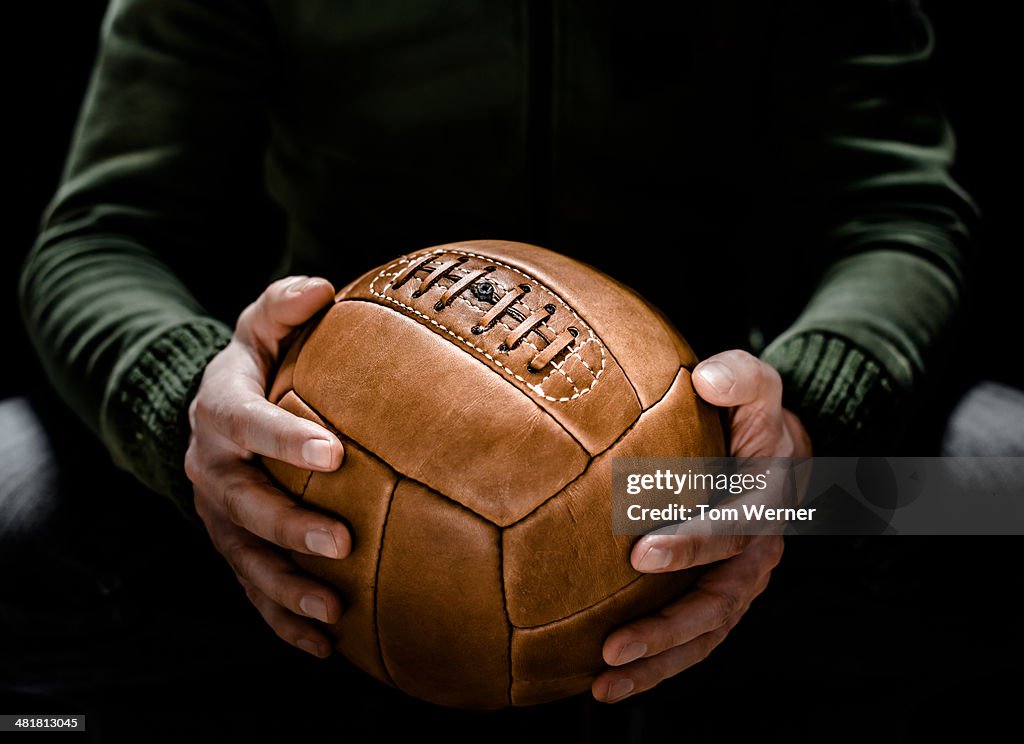 Casual man with vintage soccer ball