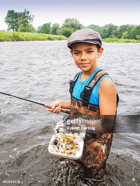 young person fly-fishing with his homemade fishing flies. - child-waders stock pictures, royalty-free photos & images