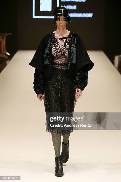 Model, wearing an outfit by the label La Folie, walks the runway at the AMD Akademie Mode & Design Best Graduate Show during Platform Fashion July...