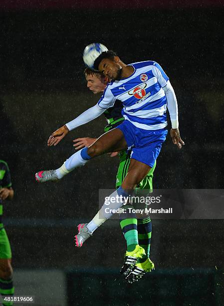 Jay Fulton of Swansea City challenges Dominic Samuel of Reading in the air during the Pre Season Friendly match between Reading and Swansea City at...