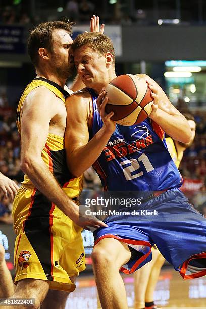 Daniel Johnson of the 36ers is blocked by Mark Worthington of the Tigers during game three of the NBL Semi Final series between the Adelaide 36ers...