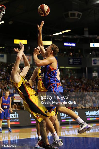 Daniel Johnson of the 36ers is blocked by Mark Worthington of the Tigers during game three of the NBL Semi Final series between the Adelaide 36ers...