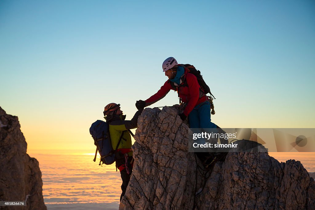 Two men climbing on rock