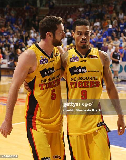 Tommy Greer and Mustapha Farrakhan of the Tigers leave the court after game three of the NBL Semi Final series between the Adelaide 36ers and the...