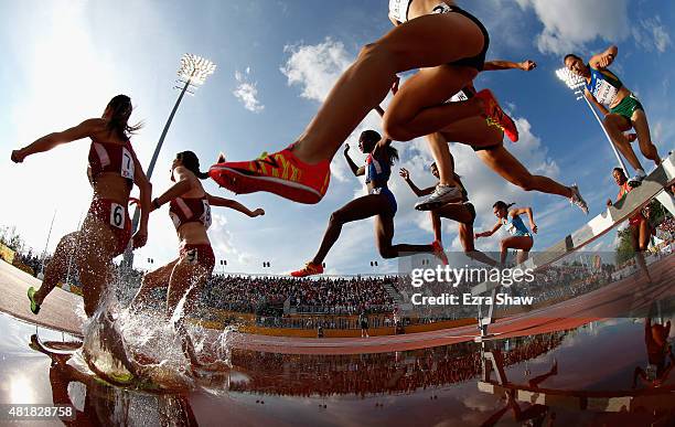 Athletes go over the water jump during the women's 3000 meter steeplechase during Day 14 of the Toronto 2015 Pan Am Games on July 24, 2015 in...