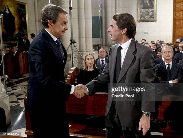 Former Spanish prime ministers Jose Luis Rodriguez Zapatero and Jose Maria Aznar shake hands while attending the state funeral ceremony for former...