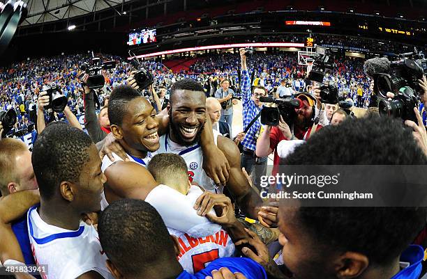 Will Yeguete and Patric Young of the Florida Gators celebrate after the SEC Men's Basketball Tournament against Kentucky Wildcats at the Georgia Dome...