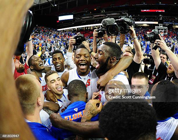 Will Yeguete and Patric Young of the Florida Gators celebrate after the SEC Men's Basketball Tournament against Kentucky Wildcats at the Georgia Dome...