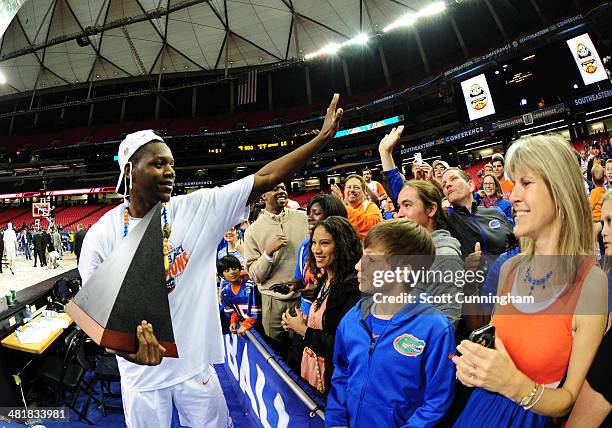 Will Yeguete of the Florida Gators celebrates after the SEC Men's Basketball Tournament against Kentucky Wildcats at the Georgia Dome on March 16,...