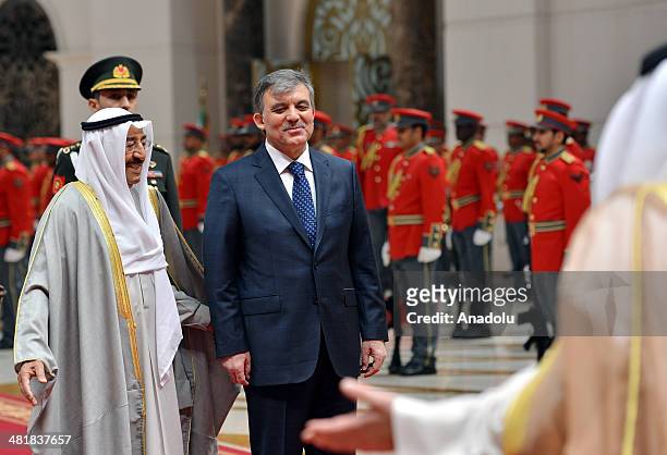 Turkish President Abdullah Gul is welcomed by Kuwait's Emir Sabah Al-Ahmad Al-Jaber Al-Sabah with a military ceremony at the airport in Kuwait, on...