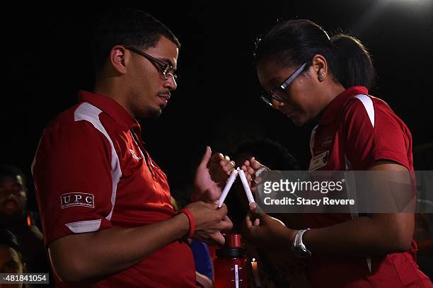 Mourners light candles during a candlelight vigil held on the campus of Louisiana Lafayette on July 24, 2015 in Lafayette, Louisiana. Two people were...