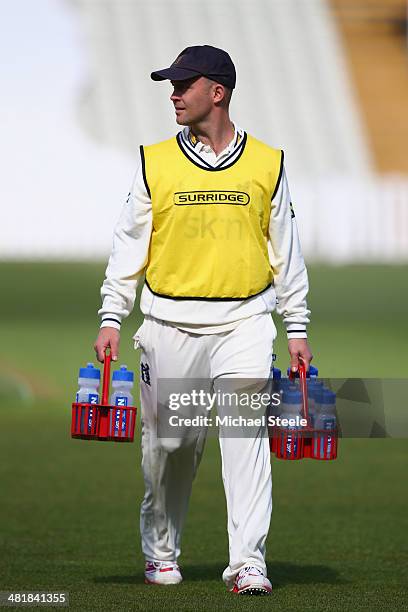 Jonathan Trott of Warwickshire carries the drinks on for team mates during the friendly match between Warwickshire and Gloucestershire at Edgbaston...