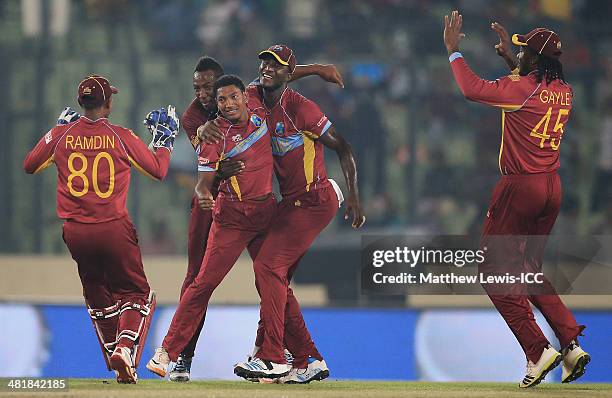 Darren Sammy of the West Indies congratulates Krishmar Santokie on bowling Ahmed Shehzad of Pakistan for LBW during the ICC World Twenty20 Bangladesh...