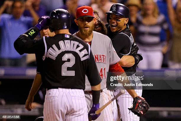 Charlie Blackmon of the Colorado Rockies celebrates with teammate Carlos Gonzalez after scoring the winning run on a wild pitch by Ryan Mattheus of...