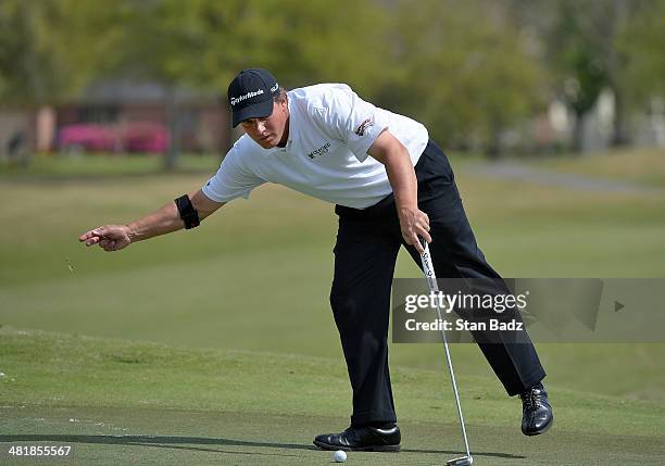 Roland Thatcher removes a leaf on the first green during the final round of the Web.com Tour Chitimacha Louisiana Open Presented by NACHER at Le...