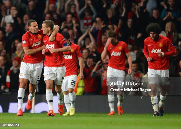 Rio Ferdinand of Manchester United congratulates Nemanja Vidic of Manchester United on scoring the opening goal during the UEFA Champions League...