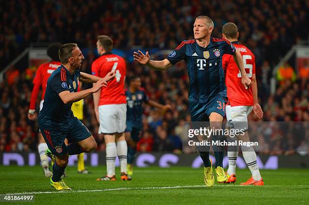 Franck Ribery of Bayern Muenchen congratulates Bastian Schweinsteiger of Bayern Muenchen on scoring their first goal during the UEFA Champions League...