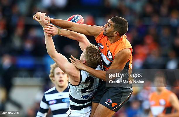 Curtly Hampton of the Giants and Josh Caddy of the Cats contest possession during the round 17 AFL match between the Greater Western Sydney Giants...