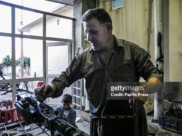 Ibrahim Hassan working in his shop. Ibrahim Hassan was born on 1973 in Korea. He is a gunsmith and an armorer from 1993 until 2013 by the Peshmerga...