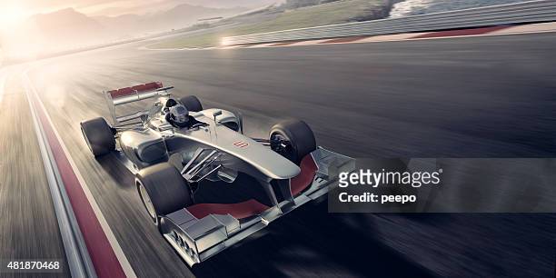 racing car bei sonnenuntergang - autorennen stock-fotos und bilder