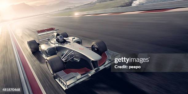 racing car at sunset - racewagen stockfoto's en -beelden