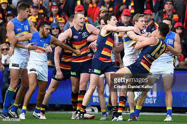 Taylor Walker of the Crows wrestles with Tom Lynch of the Suns during the round 17 AFL match between the Adelaide Crows and the GOld COast Titans at...