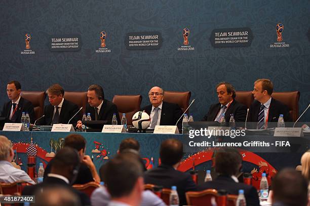 President Joseph S. Blatter speaks as Vitaly Mutko Chairman of the Local Organising Committee and UEFA President Michel Platini look on during the...