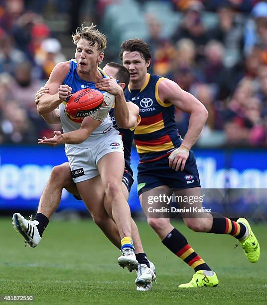 Trent McKenzie of the Suns handballs during the round 17 AFL match between the Adelaide Crows and the GOld COast Titans at Adelaide Oval on July 25,...