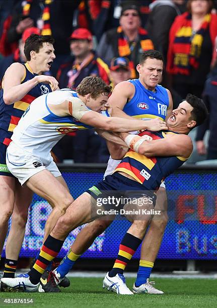 Taylor Walker of the Crows wrestles with Tom Lynch of the Suns during the round 17 AFL match between the Adelaide Crows and the GOld COast Titans at...