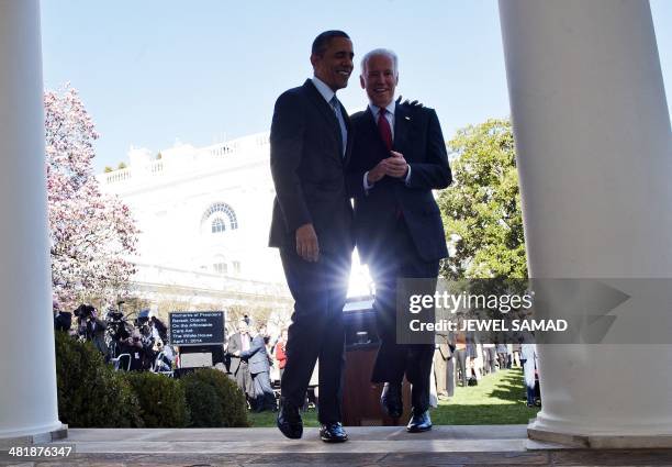 President Barack Obama walks back to the Oval Office with Vice President Joe Biden after he delivered a statement on the Affordable Care Act at the...