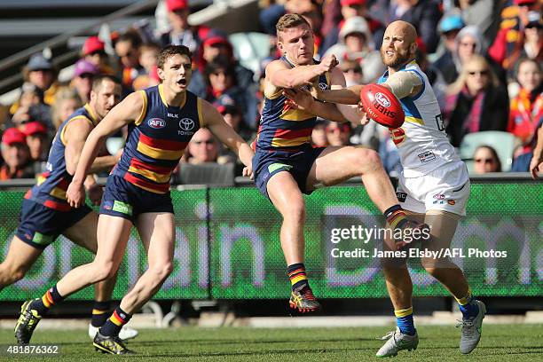 Rory Laird of the Crows competes with Gary Ablett of the Suns during the 2015 AFL round 17 match between the Adelaide Crows and the Gold Coast Suns...