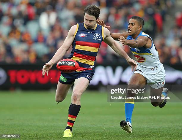 Patrick Dangerfield of the Crows gets away from Touk Miller of the Suns during the 2015 AFL round 17 match between the Adelaide Crows and the Gold...