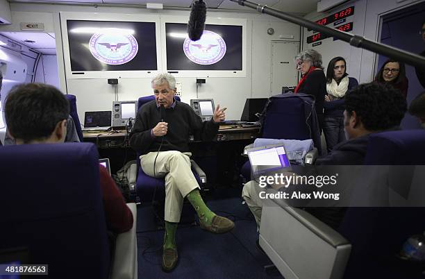 Secretary of Defense Chuck Hagel speaks to members of a travel press pool April 1, 2014 en route Honolulu, Hawaii. Secretary Hagel is heading to...