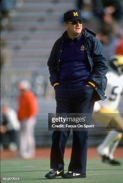 Head Coach Bo Schembechler of the Michigan Wolverines looks on while his team warms up before the start of an NCAA football game circa 1984....