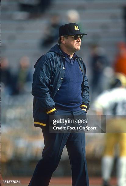 Head Coach Bo Schembechler of the Michigan Wolverines looks on while his team warms up before the start of an NCAA football game circa 1984....