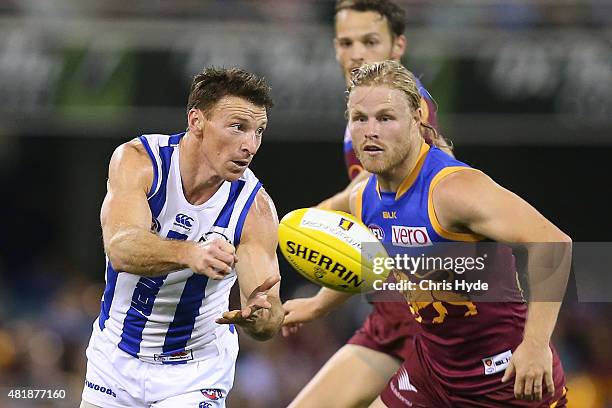 Brent Harvey of the Kangaroos handballs during the round 17 AFL match between the Brisbane Lions and the North Melbourne Kangaroos at The Gabba on...