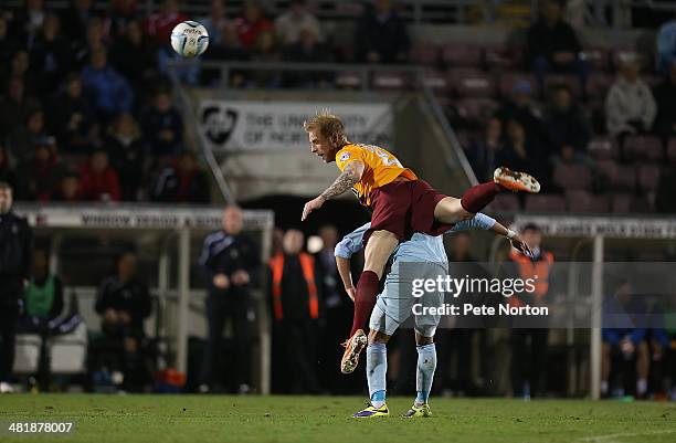 Andrew Davies of Bradford City climbs above Nathan Eccleston of Coventry City to head the ball during the Sky Bet League One match between Coventry...