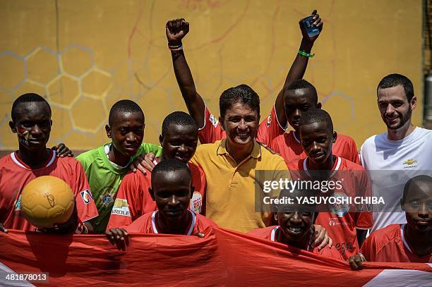 Burundian players pose with Brazilian former football player Jose Roberto Gama de Oliveira aka Bebeto during the second edition of the Street Child...