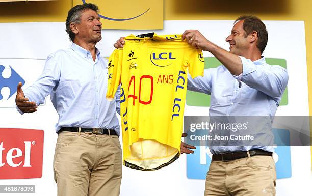 Bernard Thevenet receives from Director of Tour de France Christian Prudhomme a special yellow jersey celebrating the 40th anniversary of his victory...