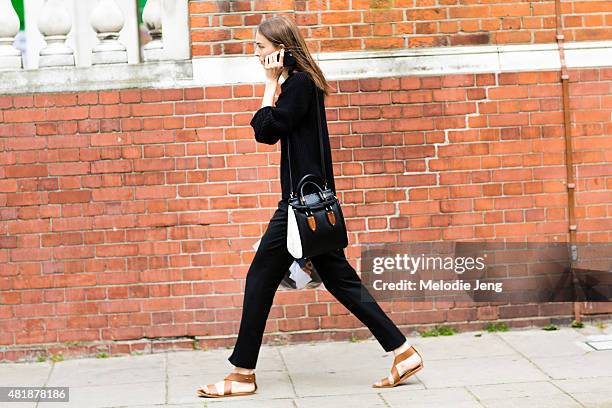 Model Julia Bergshoeff exits the Coach mens show with a Coach bag during The London Collections Men SS16 at Vincent Square on June 13, 2015 in...