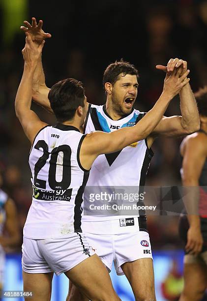 Patrick Ryder of the Power is congratulated by Chad Wingard after kicking a goal during the round 17 AFL match between the Essendon Bombers and the...