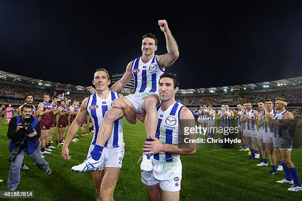Brent Harvey of the Kangaroos is chaired from the field after his 400th game during the round 17 AFL match between the Brisbane Lions and the North...