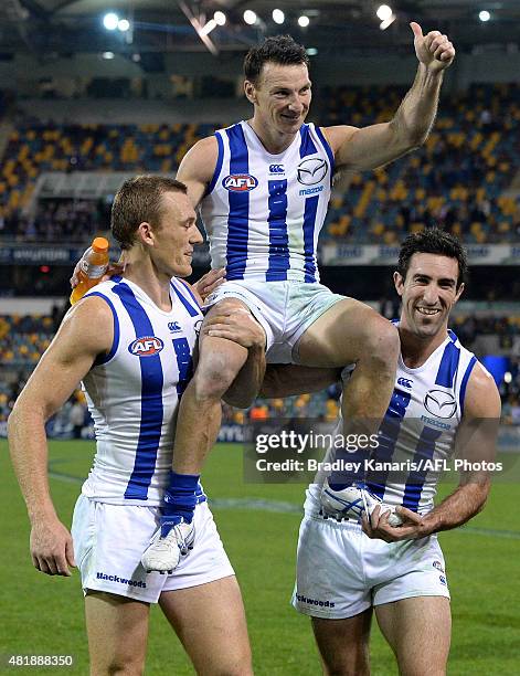 Brent Harvey of the Kangaroos is chaired off after his 400th AFL match after the round 17 AFL match between the Brisbane Lions and the North...