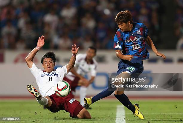 Junya Ito of Ventforet Kofu shoots at goal while Yuzo Iwakami of Matsumoto Yamaga tries to block during the J.League match between Ventforet Kofu and...