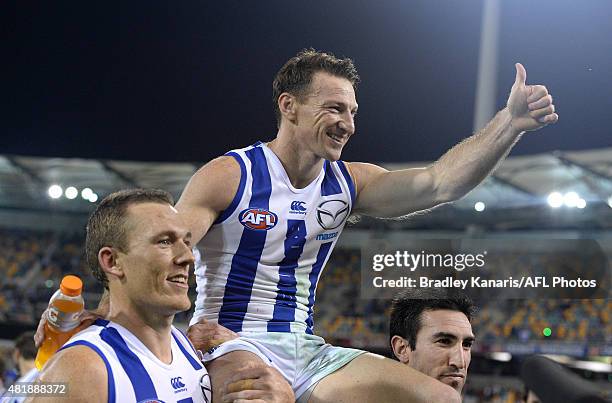 Brent Harvey of the Kangaroos is chaired off after his 400th AFL match after the round 17 AFL match between the Brisbane Lions and the North...