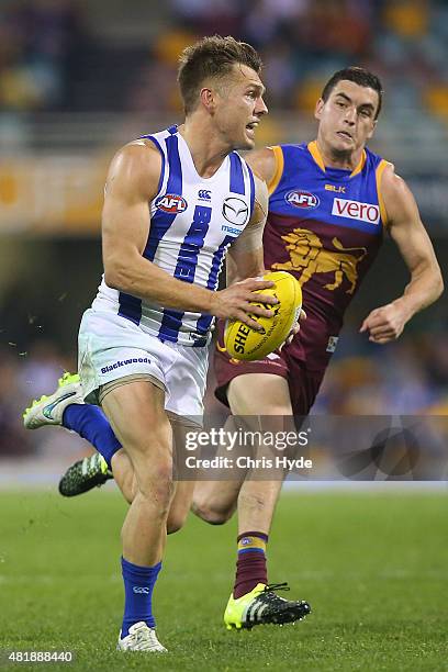 Shaun Higgins of the Kangaroos runs the ball during the round 17 AFL match between the Brisbane Lions and the North Melbourne Kangaroos at The Gabba...