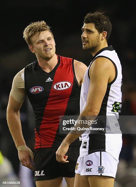 Patrick Ryder of the Power and Michael Hurley of the Bombers chat after the game during the round 17 AFL match between the Essendon Bombers and the...