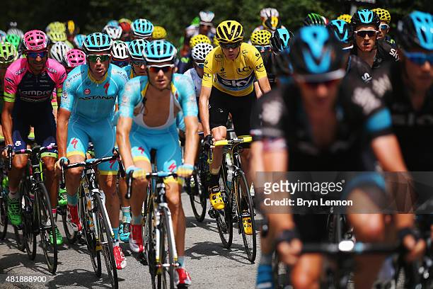 Race leader Chris Froome of Great Britain and Team Sky rides with team mates amongst the peloton during the twentieth stage of the 2015 Tour de...